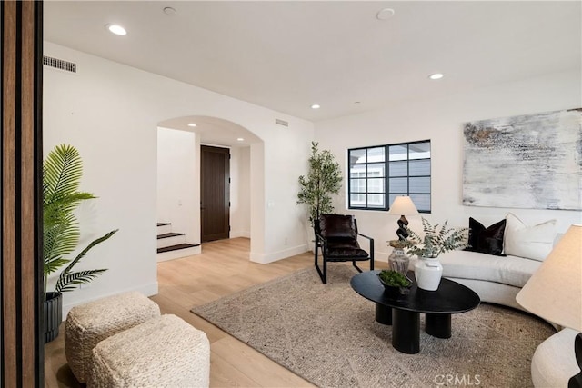 1922 Gates Ave Unit A, Redondo Beach, CA 90278 - living room featuring arched walkways, light wood finished floors, stairway, recessed lighting, and baseboards