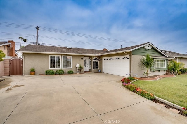 5202 Caliente Dr, Huntington Beach, CA 92649 - ranch-style house featuring a gate, stucco siding, a garage, a front yard, and concrete driveway