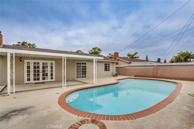 5202 Caliente Dr, Huntington Beach, CA 92649 - view of swimming pool with french doors, a patio, and a fenced backyard