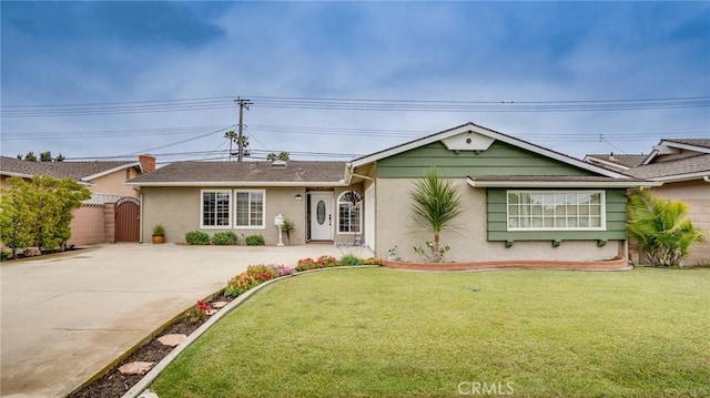 5202 Caliente Dr, Huntington Beach, CA 92649 - ranch-style house with a gate, driveway, stucco siding, and a front lawn