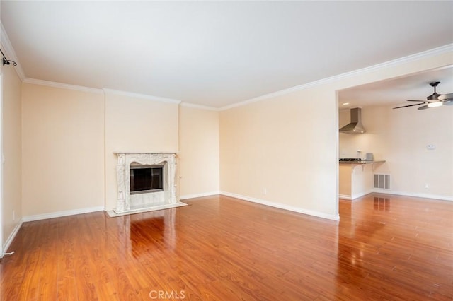 5202 Caliente Dr, Huntington Beach, CA 92649 - unfurnished living room featuring wood finished floors, ceiling fan, crown molding, baseboards, and a premium fireplace