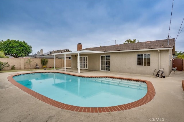5202 Caliente Dr, Huntington Beach, CA 92649 - view of swimming pool featuring a fenced backyard, a patio, and french doors