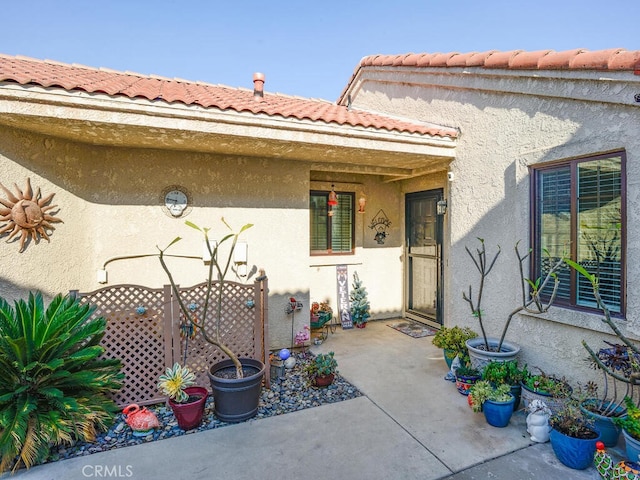 8619 San Miguel Pl, Rancho Cucamonga, CA 91730 - view of exterior entry featuring stucco siding and a tile roof