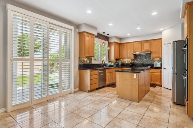 5460 Turin Way, Fontana, CA 92336 - kitchen featuring appliances with stainless steel finishes, decorative backsplash, a kitchen island, dark countertops, and light tile patterned floors