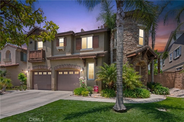 5460 Turin Way, Fontana, CA 92336 - view of front of house with stucco siding, driveway, a garage, stone siding, and a front lawn