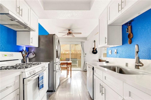 26422 Paseo Carmel Unit 20A, San Juan Capistrano, CA 92675 - kitchen featuring white gas range oven, under cabinet range hood, a sink, a ceiling fan, and stainless steel dishwasher