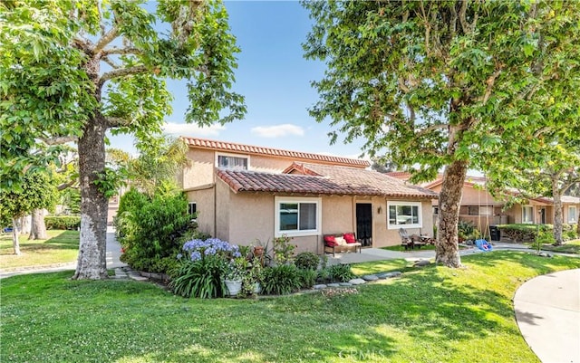 26422 Paseo Carmel Unit 20A, San Juan Capistrano, CA 92675 - view of front of home with a tile roof, stucco siding, a front yard, and a patio