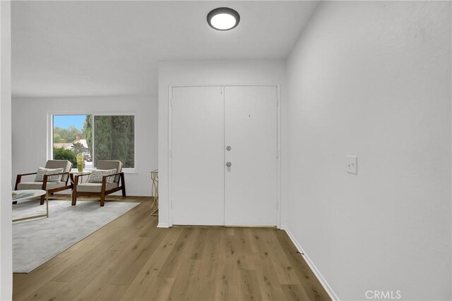 24855 Sundial Way, Moreno Valley, CA 92557 - foyer entrance featuring light wood-style floors and baseboards