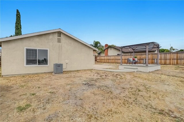 24855 Sundial Way, Moreno Valley, CA 92557 - rear view of house featuring a pergola, a fenced backyard, stucco siding, a patio, and central AC