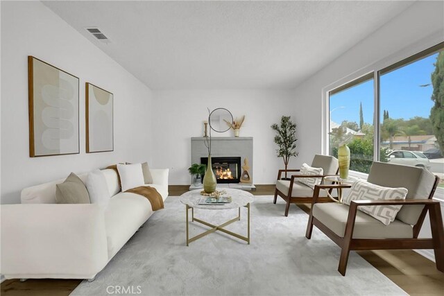 24855 Sundial Way, Moreno Valley, CA 92557 - living room featuring a glass covered fireplace and wood finished floors