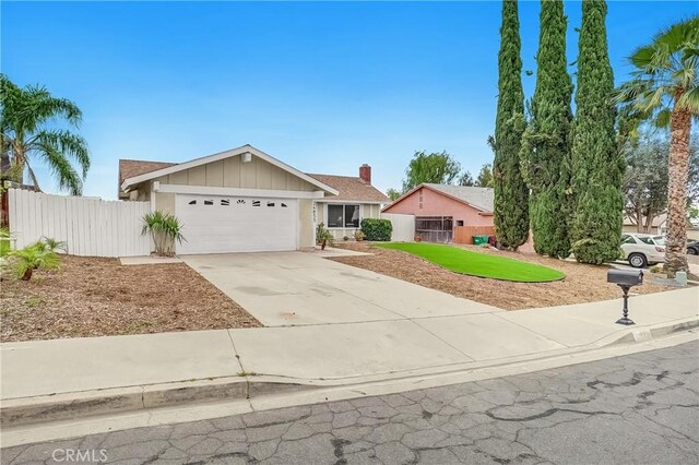 24855 Sundial Way, Moreno Valley, CA 92557 - view of front of house featuring driveway, a garage, and board and batten siding
