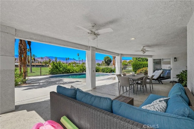 77355 Minnesota Ave, Palm Desert, CA 92211 - view of patio with an outdoor living space, ceiling fan, a mountain view, and outdoor dining area
