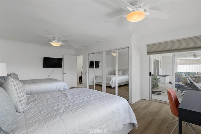 77355 Minnesota Ave, Palm Desert, CA 92211 - bedroom featuring two closets, wood finished floors, and a ceiling fan