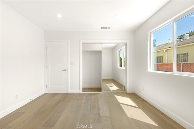 3991 Hubert Ave, Los Angeles, CA 90008 - unfurnished bedroom with light wood finished floors, baseboards, a closet, and recessed lighting