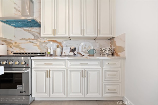 3991 Hubert Ave, Los Angeles, CA 90008 - kitchen featuring wall chimney range hood, stainless steel stove, tasteful backsplash, and light countertops