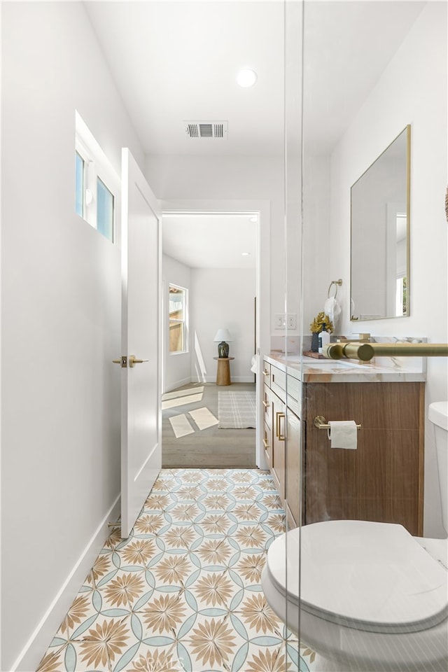 3991 Hubert Ave, Los Angeles, CA 90008 - bathroom with toilet, vanity, baseboards, recessed lighting, and tile patterned flooring