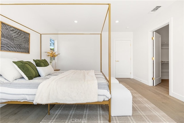 3991 Hubert Ave, Los Angeles, CA 90008 - bedroom with wood finished floors, baseboards, recessed lighting, and a walk in closet