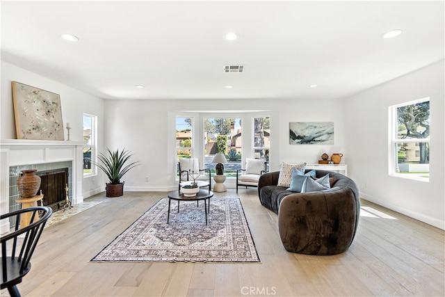 3991 Hubert Ave, Los Angeles, CA 90008 - living room with wood finished floors, recessed lighting, a tiled fireplace, and baseboards