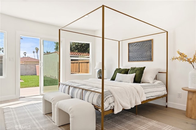 3991 Hubert Ave, Los Angeles, CA 90008 - bedroom with access to outside, baseboards, and wood finished floors