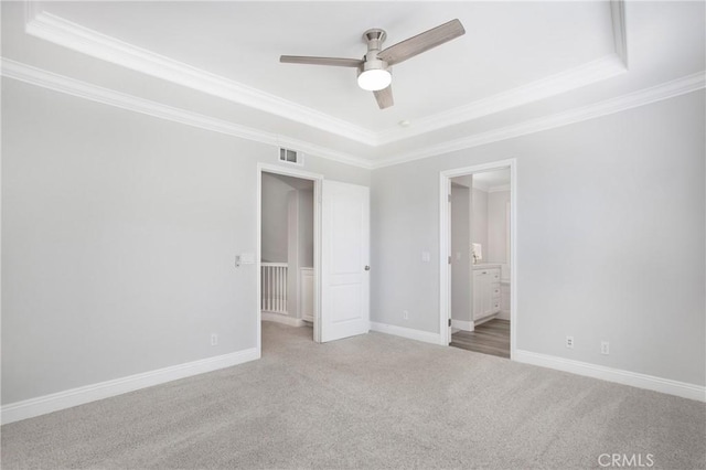 25 Bellflower St, Ladera Ranch, CA 92694 - unfurnished bedroom with a tray ceiling, ornamental molding, carpet, ensuite bathroom, and a ceiling fan