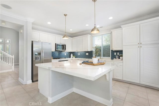 25 Bellflower St, Ladera Ranch, CA 92694 - kitchen with stainless steel appliances, a center island, white cabinetry, crown molding, and recessed lighting