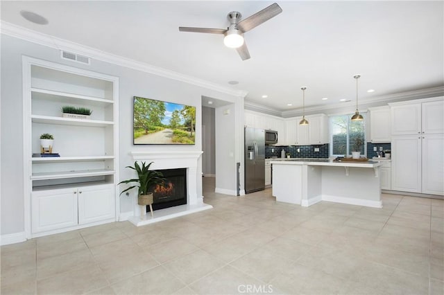 25 Bellflower St, Ladera Ranch, CA 92694 - kitchen with stainless steel appliances, crown molding, a center island, ceiling fan, and white cabinets