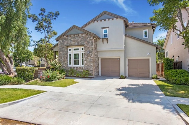 25 Bellflower St, Ladera Ranch, CA 92694 - view of front facade with stone siding, an attached garage, stucco siding, and concrete driveway