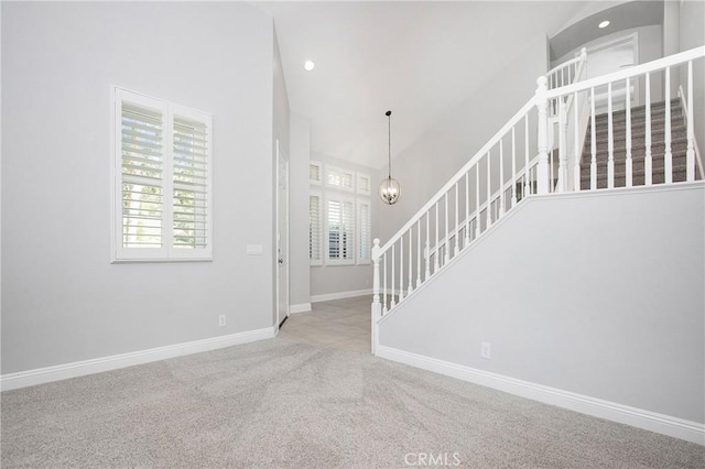 25 Bellflower St, Ladera Ranch, CA 92694 - unfurnished living room featuring healthy amount of natural light, stairway, carpet flooring, recessed lighting, and a high ceiling