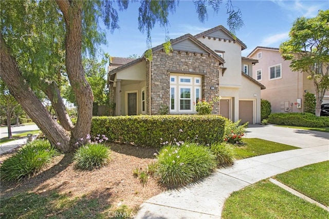 25 Bellflower St, Ladera Ranch, CA 92694 - view of front of home featuring stucco siding, stone siding, concrete driveway, and a garage
