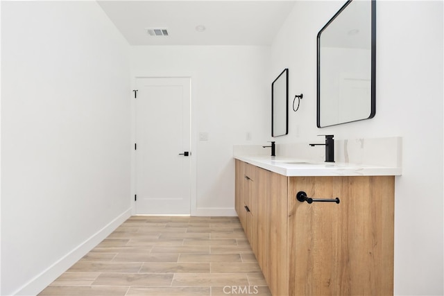 3927 Welland Ave, Los Angeles, CA 90008 - bathroom with baseboards, double vanity, and wood finished floors