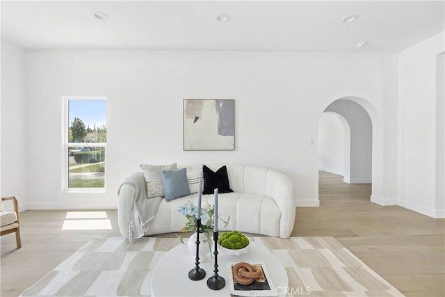 3927 Welland Ave, Los Angeles, CA 90008 - living area featuring baseboards, arched walkways, light wood-style floors, and recessed lighting