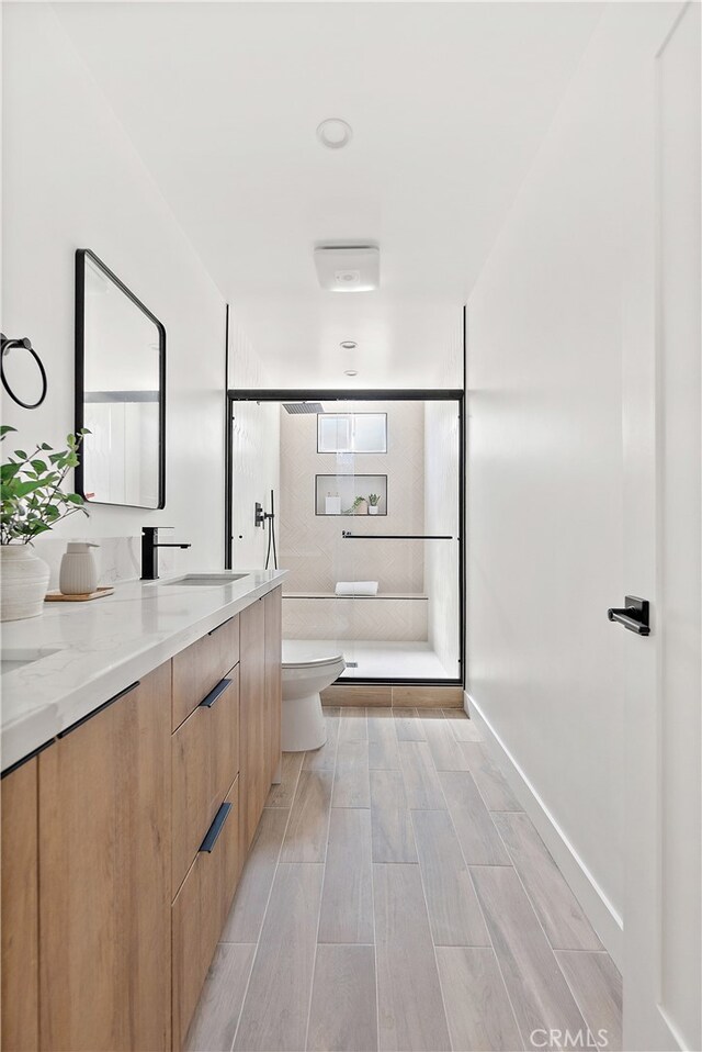 3927 Welland Ave, Los Angeles, CA 90008 - full bath with toilet, vanity, a stall shower, and wood finished floors