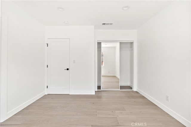 3927 Welland Ave, Los Angeles, CA 90008 - unfurnished bedroom featuring a closet, light wood-style flooring, and baseboards