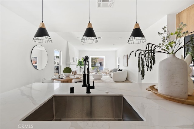 3927 Welland Ave, Los Angeles, CA 90008 - kitchen featuring a sink, decorative light fixtures, open floor plan, and light stone counters