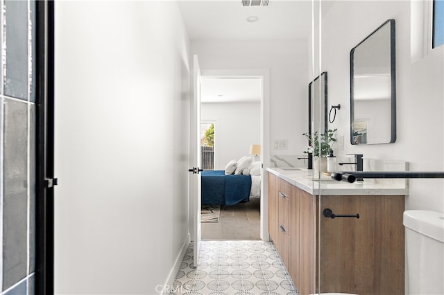 3927 Welland Ave, Los Angeles, CA 90008 - bathroom featuring double vanity, toilet, tile patterned floors, and connected bathroom