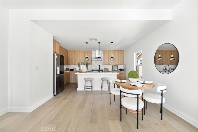3927 Welland Ave, Los Angeles, CA 90008 - dining area with light wood finished floors and baseboards