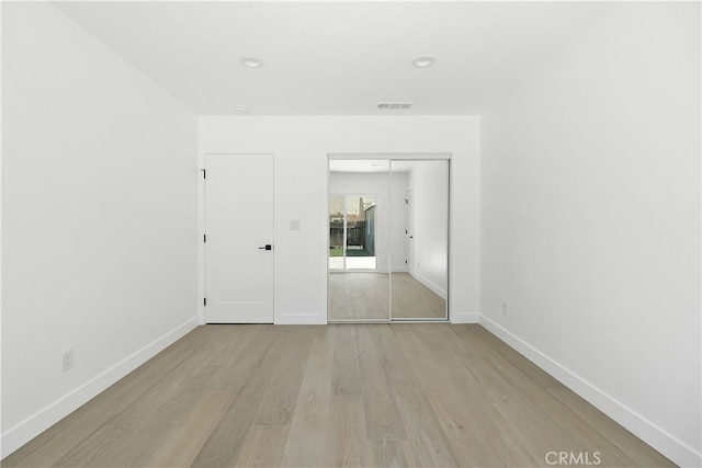 3927 Welland Ave, Los Angeles, CA 90008 - unfurnished bedroom featuring light wood-type flooring, baseboards, a closet, and recessed lighting