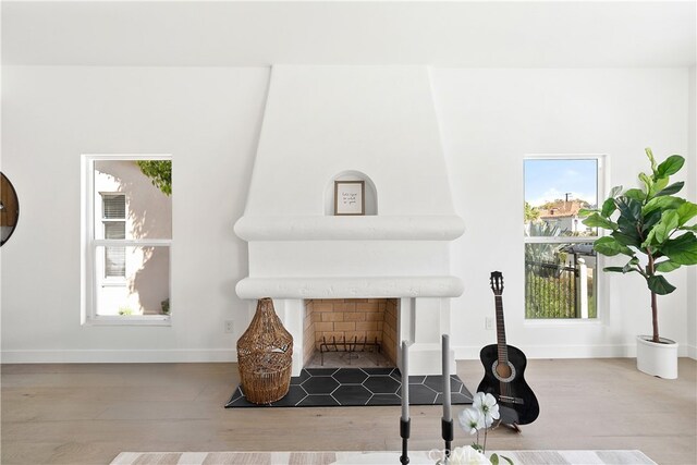 3927 Welland Ave, Los Angeles, CA 90008 - detailed view of baseboards, wood finished floors, and a fireplace