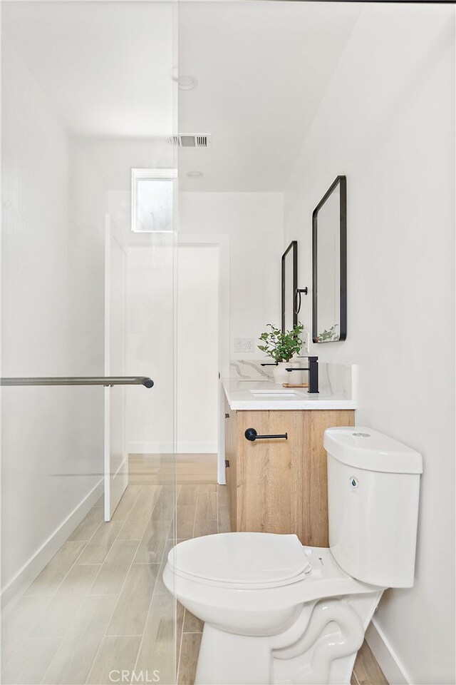 3927 Welland Ave, Los Angeles, CA 90008 - bathroom featuring vanity, baseboards, toilet, and a shower