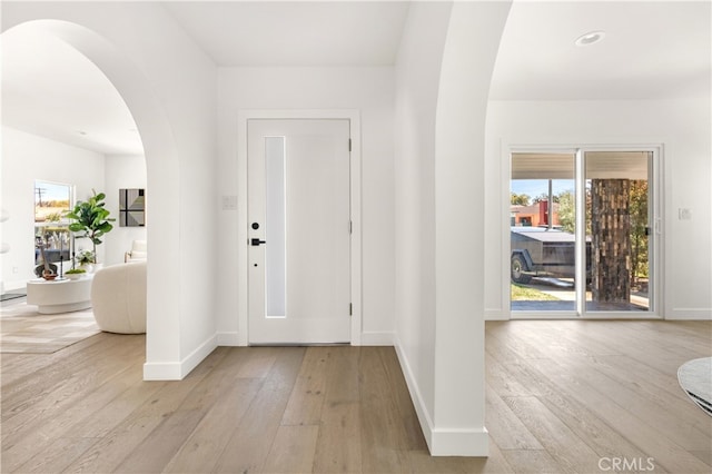 3927 Welland Ave, Los Angeles, CA 90008 - entrance foyer featuring arched walkways, light wood finished floors, baseboards, and recessed lighting