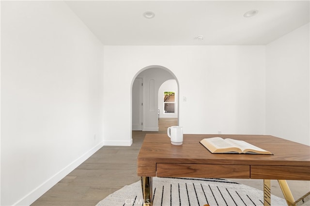 3927 Welland Ave, Los Angeles, CA 90008 - dining area with arched walkways, baseboards, and wood finished floors