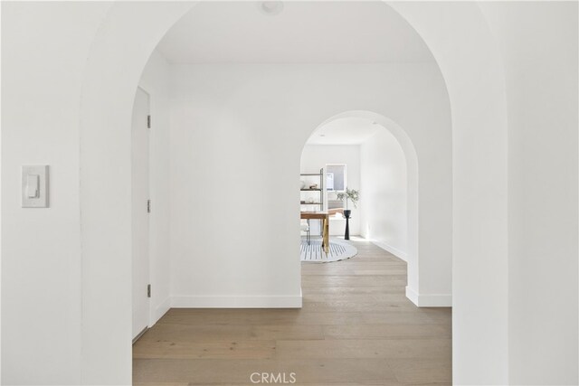 3927 Welland Ave, Los Angeles, CA 90008 - hall featuring hardwood / wood-style flooring, baseboards, and arched walkways