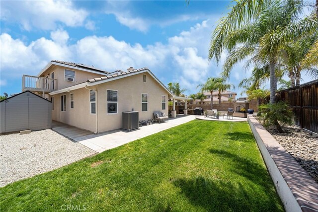 29183 Paperflower Ln, Menifee, CA 92584 - back of property featuring central AC unit, solar panels, stucco siding, and a patio area