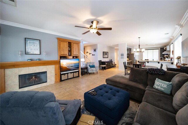 29183 Paperflower Ln, Menifee, CA 92584 - living area with a ceiling fan, a fireplace, a chandelier, ornamental molding, and light tile patterned floors