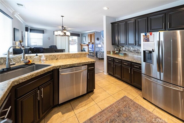 29183 Paperflower Ln, Menifee, CA 92584 - kitchen with stainless steel appliances, a sink, open floor plan, light tile patterned floors, and backsplash