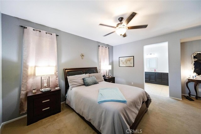 29183 Paperflower Ln, Menifee, CA 92584 - bedroom featuring light colored carpet, ensuite bathroom, a ceiling fan, and baseboards