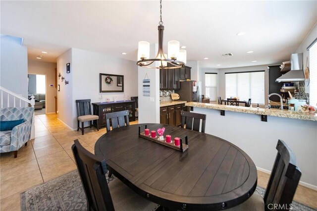 29183 Paperflower Ln, Menifee, CA 92584 - dining area with a chandelier, light tile patterned flooring, recessed lighting, stairs, and baseboards