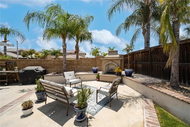 29183 Paperflower Ln, Menifee, CA 92584 - fenced backyard with a patio area, a grill, and an outdoor living space with a fireplace