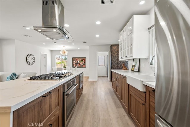 2116 E Thackery St, West Covina, CA 91791 - kitchen featuring appliances with stainless steel finishes, island exhaust hood, brown cabinetry, recessed lighting, and white cabinetry