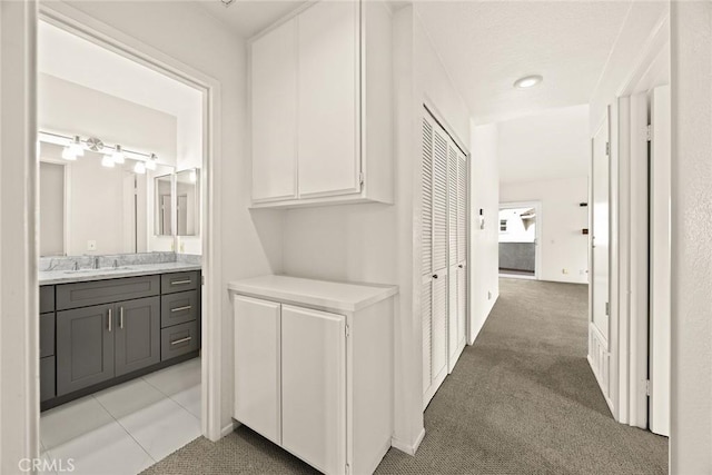 549 Springbrook N, Irvine, CA 92614 - corridor featuring a sink and light colored carpet